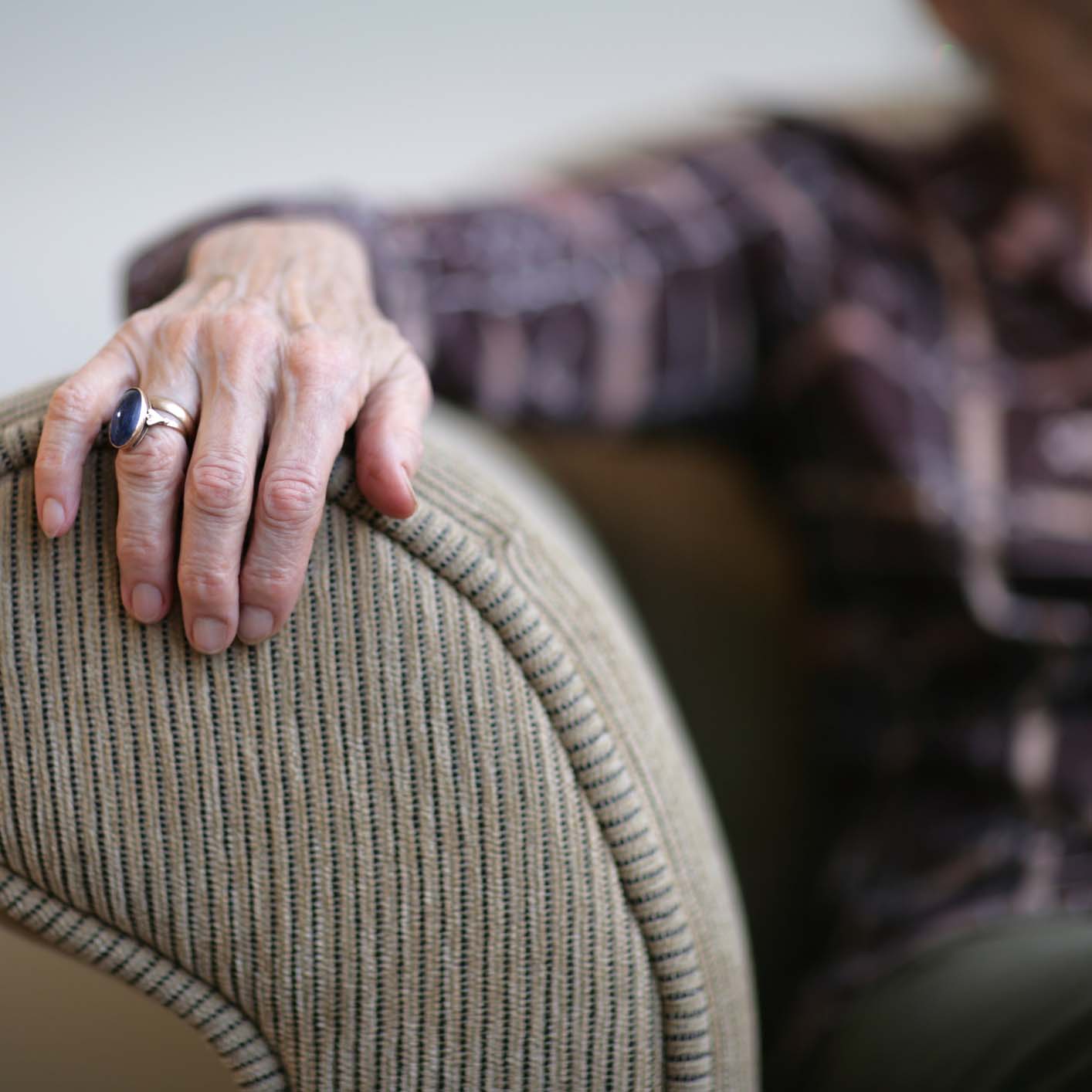 COVID Update Senior woman hand on an armrest